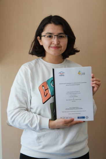 A photo of Dilfuza and her PhD thesis